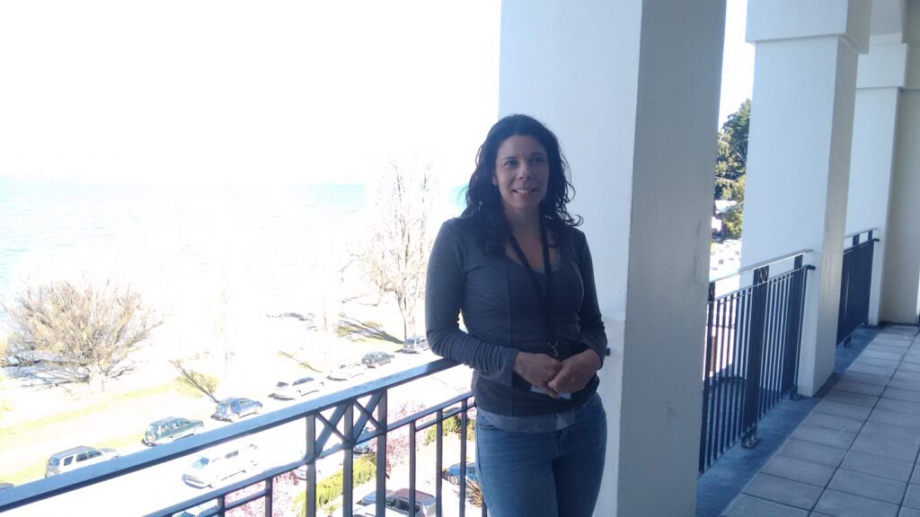 Sara Ferreira standing on the verandah of the Rydges hotel in Queenstown.