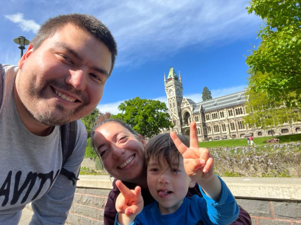 Benjamín Durán-Vinet with wife Karla and son Máximo with the University of Otago's clocktower in the background.
